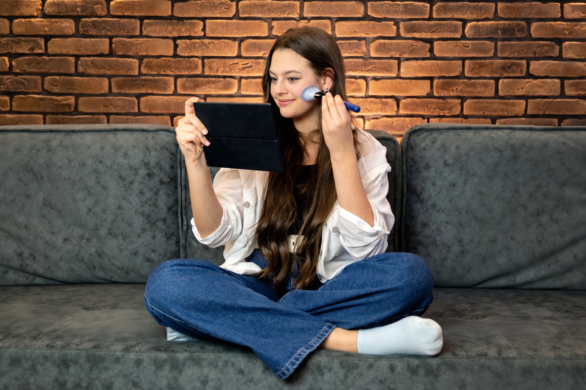 A young smiling woman making make-up